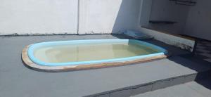 a blue tub sitting on the ground next to a building at Casa para a COP 30 in Barcarena