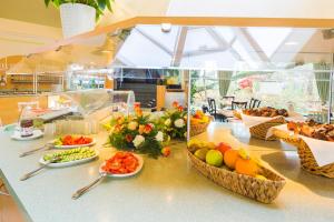 a counter with a bunch of fruits and vegetables on it at Hotel Am Terrassenufer in Dresden