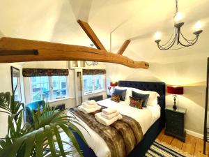 a bedroom with a large bed in a room at The Clock House in Chichester