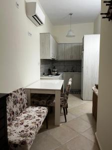 a kitchen with a table and a couch in a room at Kantouni house Chios in Pyrgi +11 photos
