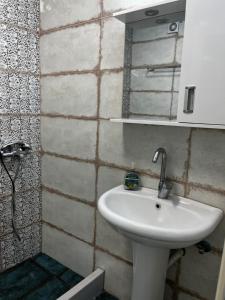 a bathroom with a white sink and a mirror at Kantouni house Chios in Pyrgi