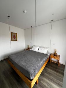 a bedroom with a large bed with glass walls at The Spot Ofir in Esposende