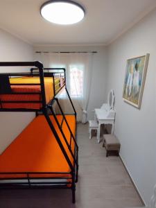 a room with a bunk bed and a table at EAR - house Karia Lefkada in Kariá