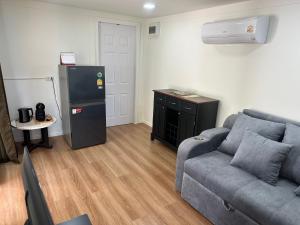 a living room with a couch and a refrigerator at The Aura Pranburi in Ban Tha Khoi