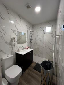a bathroom with a toilet and a sink and a shower at The Spot Ofir in Esposende