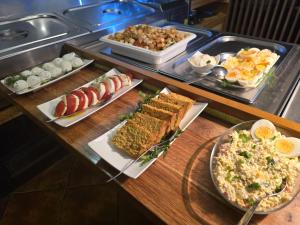 a buffet with different types of food on a table at Zielony Dom in Bolesławiec