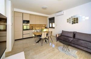 a living room with a couch and a table at Sunny Oasis in Bibinje