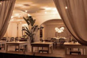 a restaurant with tables and chairs in a room at Ostuni Torre Pozzelle Open Air in Ostuni Costa Merlata