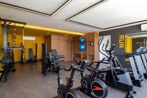 a gym with treadmills and exercise bikes in a room at Lille Cambui Studios Luxo by Robert Stays in Campinas