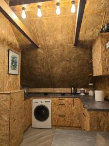 a kitchen with a washer and dryer in a room at D-club in Senta
