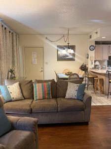 a living room with a couch and a kitchen at River Place Condos #110 3BD in Pigeon Forge