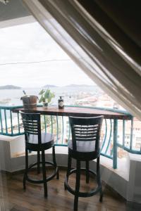 a table and two chairs in front of a window at Petronella Luxury Penthouse marina court in Kota Kinabalu