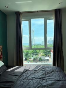 Ένα ή περισσότερα κρεβάτια σε δωμάτιο στο Pattaya Park View Comfort Room