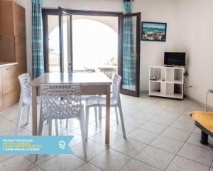 a dining room with a table and chairs at RS315 - Marcelli, bilocale in residence fronte mare in Marcelli +14 photos