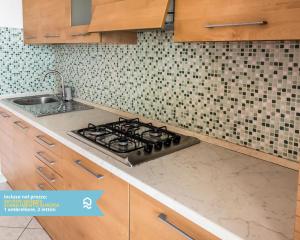 a kitchen counter with a stove and a sink at RS315 - Marcelli, bilocale in residence fronte mare in Marcelli