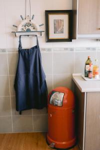 a blue bag hanging on a wall next to a trash can at Petronella Luxury Penthouse marina court in Kota Kinabalu