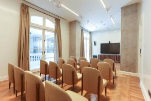 a conference room with a podium and a tv at Recoleta Grand, Buenos Aires, a Tribute Portfolio Hotel in Buenos Aires +86 photos