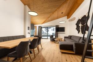 a living room with a couch and a table at Pure Alpine Suites in Schladming