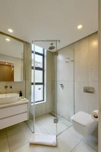 a bathroom with a shower and a toilet and a sink at 7 on Bantry Luxury Residence 305 in Cape Town +17 photos
