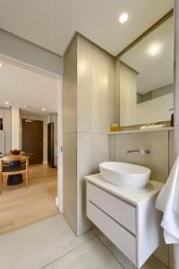 a white bathroom with a sink and a table at 7 on Bantry Luxury Residence 305 in Cape Town