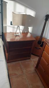 a table with a lamp and a guitar next to a bed at Il Giardino Del Nespolo in Arcola +63 photos