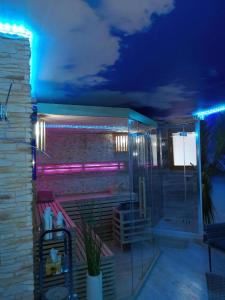 a room with a shower with purple lights at Ferienwohnung Maaridyll In Schalkenmehren in Schalkenmehren