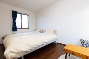 Ένα ή περισσότερα κρεβάτια σε δωμάτιο στο 001T 夢Y's INN Nirinso 中板橋 中板橋駅徒歩3分 3ldkまるごと貸切 池袋駅まで3駅8分 お花見スポット 飲食店多数