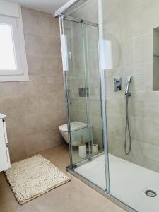 a glass shower in a bathroom with a toilet at Modern new Pool Villa in San Pedro del Pinatar +24 photos