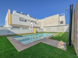 a swimming pool in front of a building at Villamar 6 in San Pedro del Pinatar