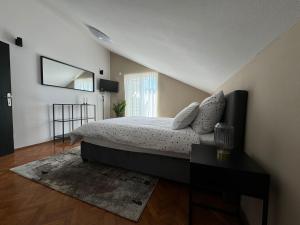 a bedroom with a large bed and a window at Hotel Buenavista Beach House Trogir in Trogir