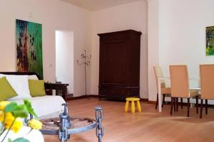 a living room with a couch and a table with chairs at La Siciliana in Acireale +35 photos