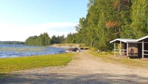 a cabin on the shore of a lake at After Work Escape with sauna and balcony in Joensuu