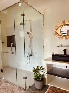 a shower in a bathroom with a sink and a mirror at Calma - Surf, Yoga & Coffee on a Private Beach in Dickwella +37 photos