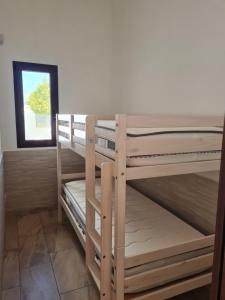 two bunk beds in a room with a window at Villa Fede&Edo in Surbo