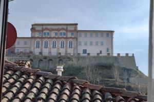 a large building on top of a hill with a roof at Casa Gialla Soggiorno Panorama in Centro Storico in Dogliani