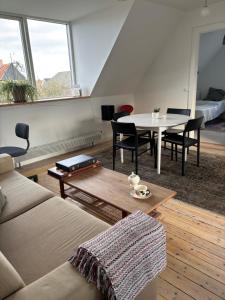 a living room with a couch and a table at Kleiters Bed & Kitchen in Copenhagen