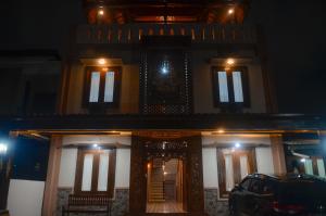 a house with a car parked in front of it at night at Casa De Leren in Ngabean