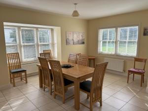 a dining room with a wooden table and chairs at Number 7 Bank House in Schull