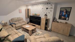a living room with couches and a flat screen tv at Haus Margarete in Warstein