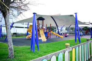 a park with a playground with a slide at Apartamento AJO 2 habitaciones piscina y tenis in Ajo