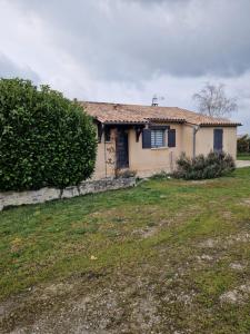 a small house with a grass yard in front of it at Chambre d'hôtes in Saint-Martial-de-Valette