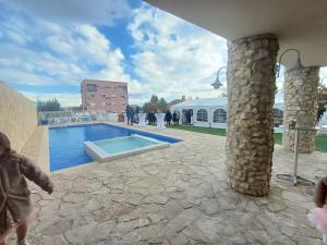 a small child is standing next to a swimming pool at Casa Bevanda in Međugorje