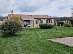a small house with a grassy yard in front of it at Chambre d'hôtes in Saint-Martial-de-Valette