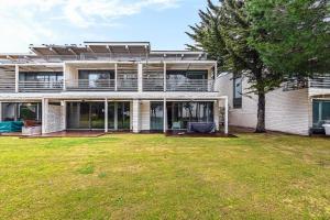 a large house with a yard in front of it at Villa Oasis in Troia