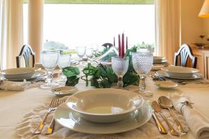 a table with plates and glasses on a table at The Princess Ring View in Vila Franca do Campo