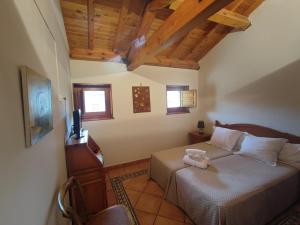 a bedroom with a bed with a tv on it at Posada de Serrada in Serrada de la Fuente