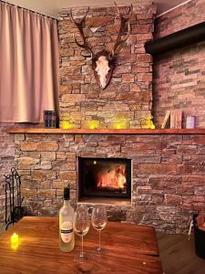 two wine glasses on a table in front of a fireplace at Luxus Spa auf tollem Anwesen in Neubulach