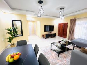 a living room with a table with fruit on it at Jacobi Apartments in Kitwe