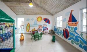 a room with a childrens mural on the wall at Arraial do Cabo. Conforto, Piscina, Vista Mar. in Arraial do Cabo