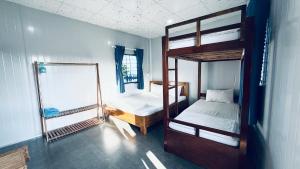 una stanza con due letti a castello e uno specchio di Phước Đồng Homestay - Cù Lao Mái Nhà a Tuy An Altre 52 foto